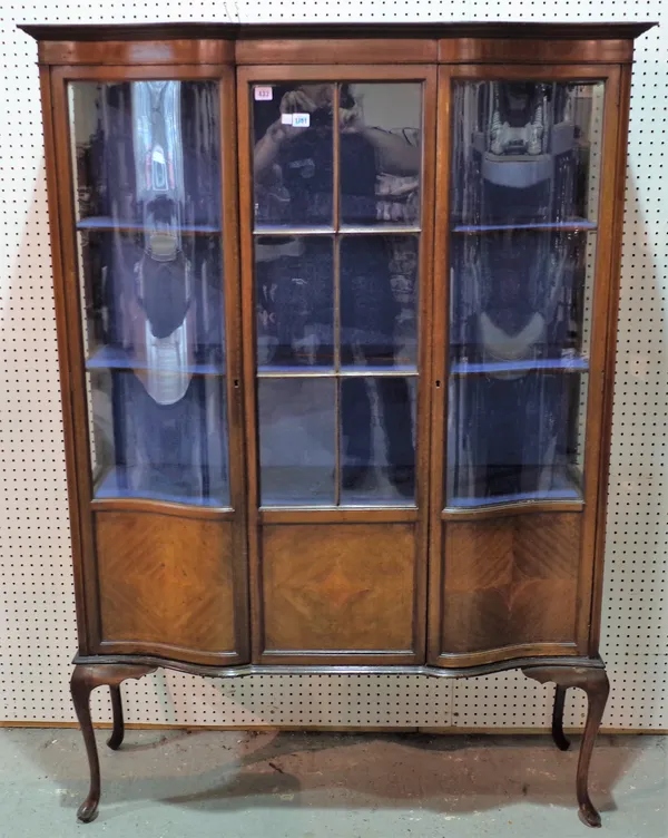 An Edwardian inlaid mahogany display cabinet, the serpentine front with a pair of semi-glazed doors, flanked by glazed sides, on cabriole supports, 12