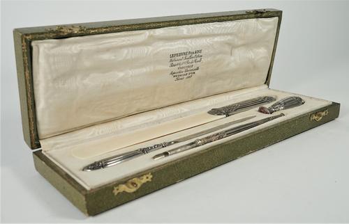 A French silver mounted four piece desk set, comprising; a page turner, a paper knife, a seal and a dip pen, with a case.