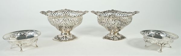 Two similar late Victorian silver pedestal bonbon dishes, each with cast and pierced floral and foliate decoration and raised on a pierced foot, lengt