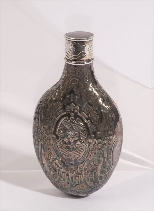 A Victorian silver spirit flask, of oval form with engraved decoration, having a screw top, crest engraved, Birmingham (date letter indistinct), weigh