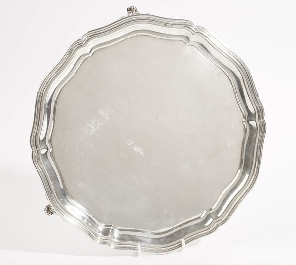 A Russian salver of shaped circular form, raised on three foliate feet, 1863, detailed 84, diameter 29cm, weight 741 gms.   Part 6630.