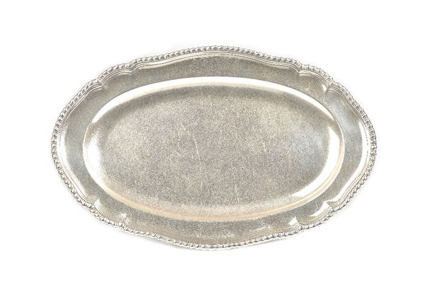 A George III silver shaped oval serving dish, having a decorated rim, armorial engraved, length 37cm, London 1766, weight 866 gms. Illustrated.