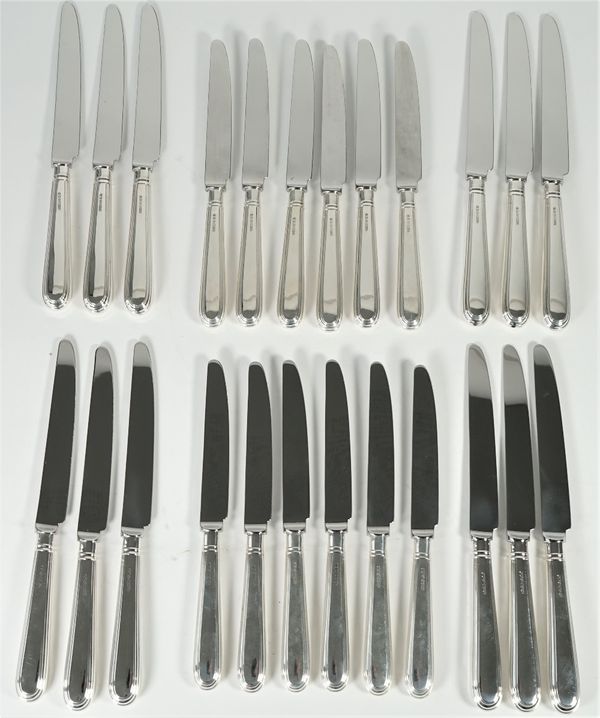 A set of twelve table knives, having loaded silver handles and steel blades and a matching set of twelve cheese knives, having loaded silver handles a