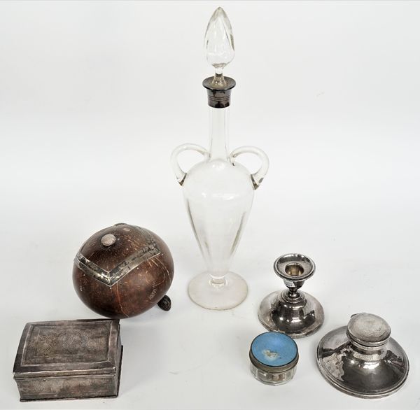 A silver mounted glass decanter of twin handled amphora form, Birmingham 1906, a capstan shaped inkstand, Chester 1918, one candlestick (loaded), Birm