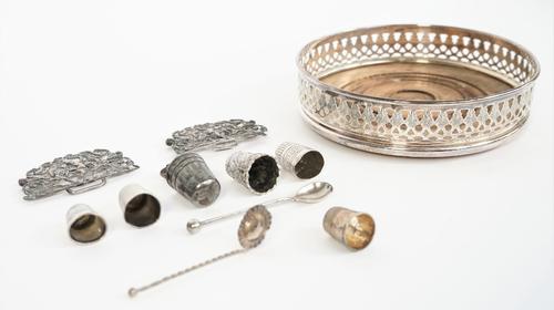 Silver and silver mounted wares, comprising; a circular bottle coaster, with pierced decoration to the gallery and with a turned wooden base, London 1