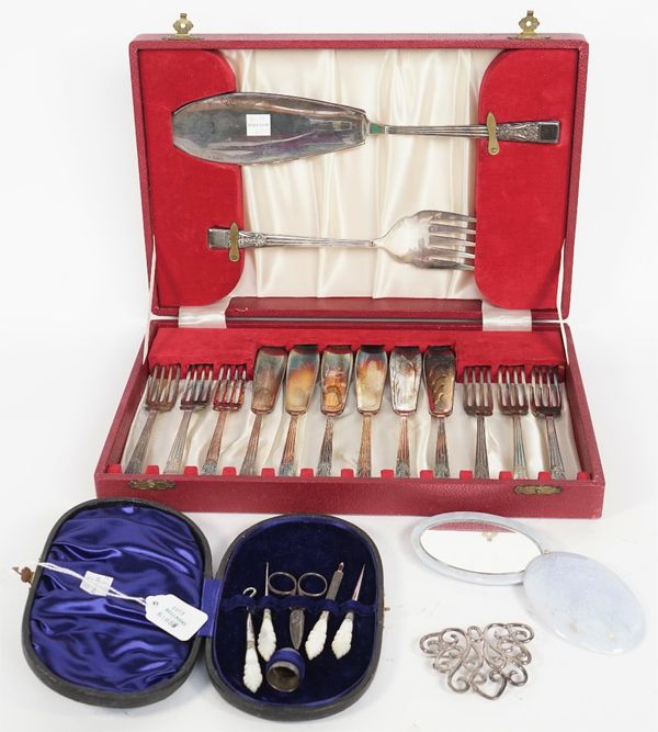 A set of six pairs of plated fish knives and forks and a pair of matching fish servers, cased, an oval pale mauve stained hardstone folding mirror, a