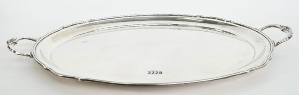 A silver shaped oval twin handled tray, having cast motifs to the handles and with a reeded rim, Sheffield 1975, length 60cm, gross weight 2295 gms.