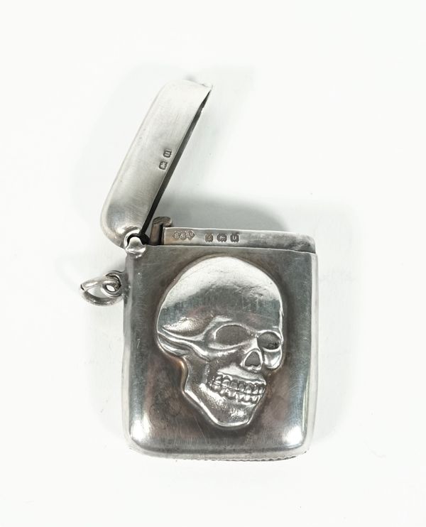 A silver vesta case, the front with an applied skull motif otherwise plain, by Smith & Bartlam, Birmingham 1919, weight 43 gms.