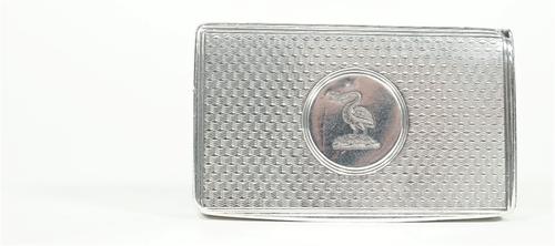 A Victorian silver vesta case, of rectangular form, having all over engine turned decoration, the centre of the cover with a circular plaque engraved