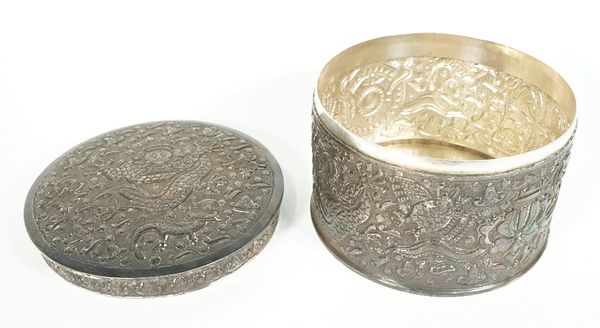 A foreign circular lidded box, decorated with masks and animals to the body and to the detachable lid, detailed PAK 94 SIL, diameter 15.5cm, height 11