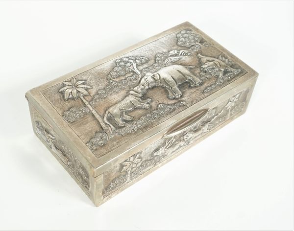 An Asian rectangular hinge lidded table cigarette box, decorated with elephants and other animals in jungle scenes, (the interior lining lacking), pos