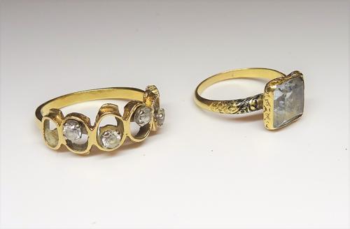 A gold and colourless gem set ring, of oval looped abstract design, detailed 18 CT, gross weight 4.5 gms, ring size U and a gold and foil backed colou