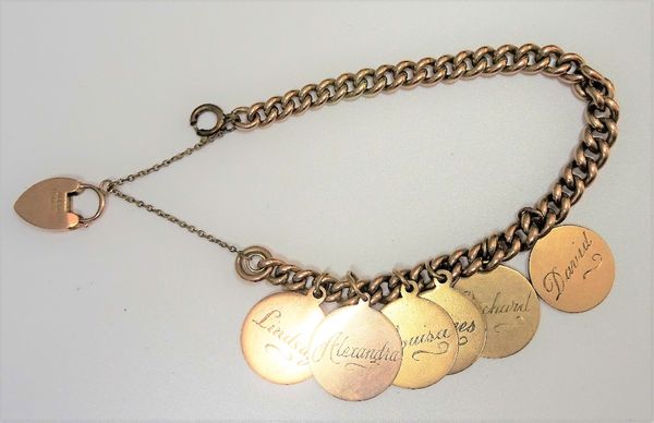 A gold curb link bracelet, with a 9ct gold heart shaped padlock clasp and a gilt metal boltring clasp, the bracelet fitted with six gold disc shaped p