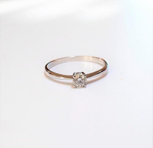 An 18ct white gold and diamond single stone ring, claw set with a circular cut diamond, detailed DIA 025, ring size P and a half, gross weight 1.8 gms