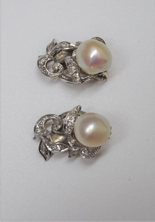 A pair of diamond and cultured pearl set earclips, each designed as a foliate scrolling spray, mounted with a single cultured pearl at the top and oth