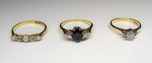 A gold, sapphire and diamond set three stone ring, claw set with the oval cut sapphire between two circular cut diamonds, a 9ct gold and diamond set s