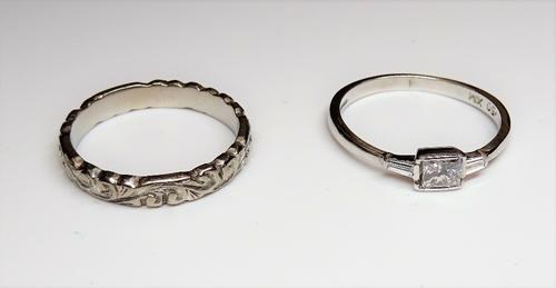 An 18ct white gold and diamond ring, mounted with the principal princess cut diamond to the centre, between baguette diamond set sides, detailed .50,