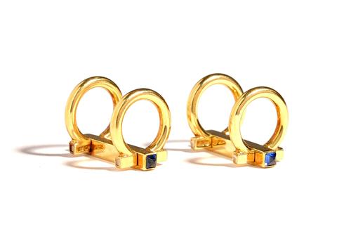 A pair of 18ct gold and sapphire cufflinks, each of twin loop and bar form, with faceted square cut sapphire terminals, gross weight 9.2 gms, with a H