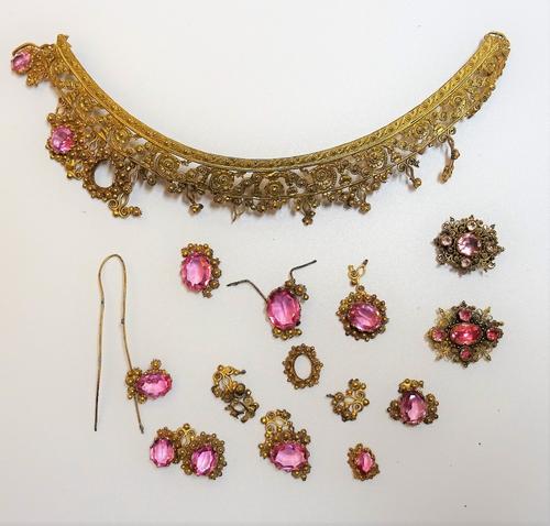 A pink foil backed topaz cannetille work clasp, a pink foil backed topaz cannetille work oval panel and part of a gilt metal and paste set tiara in se