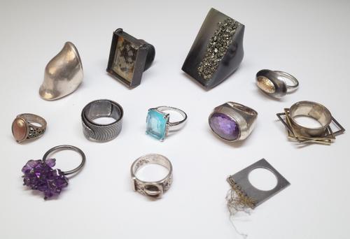A silver ring, mounted with an oval cut amethyst, detailed M & J Savitt Sterling and eleven further rings, including many of abstract modern design, (