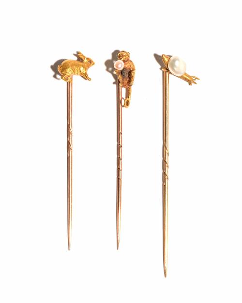 A gold and cultured pearl stick pin, modelled as a monkey, detailed 18, a cultured pearl stick pin, modelled as a snail and another stick pin, modelle
