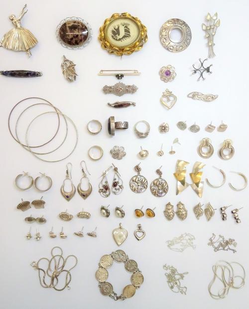 Silver and other jewellery, comprising; a Victorian oval brooch, with a stag motif, thirteen further brooches, four rings, twenty pairs of earrings, t