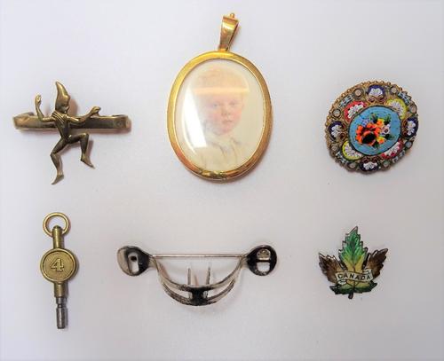A gold mounted oval pendant locket, detailed 15 CT, glazed with a portrait miniature of a child , four brooches and a watch key, (6). 6620