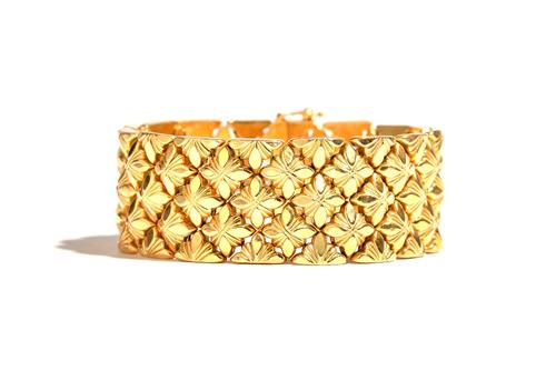 An 18ct gold wide bracelet, designed as a series of lozenge shaped floral links, on a snap clasp, length 19cm, import mark Birmingham 1960, weight 52.