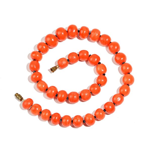 A single row necklace of graduated coral beads, on a base metal clasp, length of necklace excluding clasp 37cm, diameter of largest bead 13mm, gross w