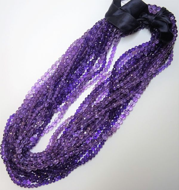 Eighteen rows of faceted amethyst quartz beads, (18). 6599