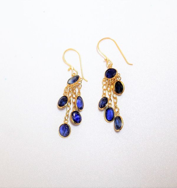 A pair of sapphire set pendant earrings of fringe design, mounted with oval cut sapphires, suspended from trace link chains to hook fitments, weight 1