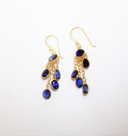 A pair of sapphire set pendant earrings of fringe design, mounted with oval cut sapphires, suspended from trace link chains to hook fitments, weight 1