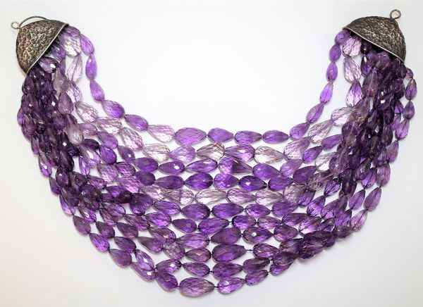 An eleven row amethyst quartz bead necklace, formed as a row of graduated pear shaped faceted amethyst quartz beads, on a hook and loop shaped clasp,