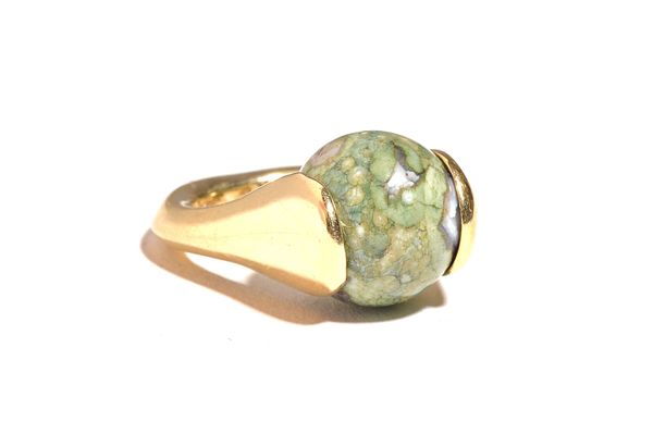 A gold ring, mounted with a spherical green agate bead, detailed 14 K (possibly loaded), ring size G (note shank is not circular). Illustrated.