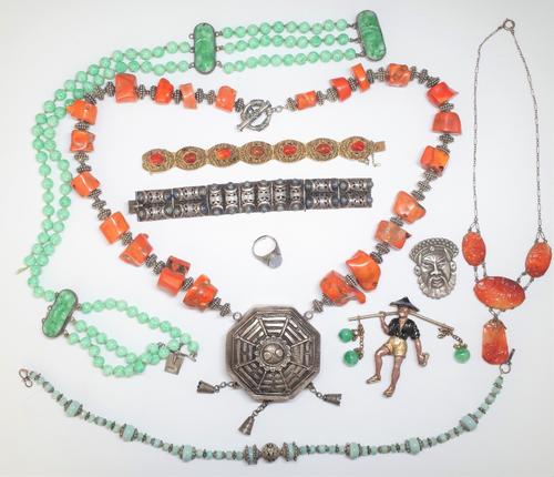 A group of Asian style and Chinese jewellery, comprising; a panel link bracelet, detailed Made In China, a gilt filigree and cornelian bracelet, on a