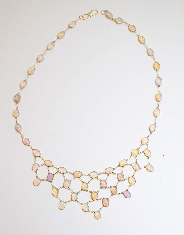 A gold and opal fringe necklace, collet set with oval cabochon opals, between yellow precious metal links to a hook clasp, 42.5cm long, gross weight 7