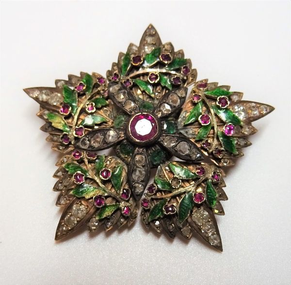 A gold, diamond, ruby set and green enamelled brooch, designed as a five pointed star and a green enamelled wreath, mounted with the principal cushion