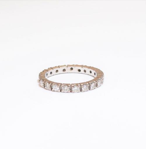 A diamond set full eternity ring, mounted with circular cut diamonds (two diamond lacking), ring size I and a half, gross weight 2.4 gms.