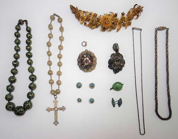 A group of mostly Asian and filigree jewellery, comprising; a turquoise matrix bead necklace, a filigree bead necklace with a pendant cross, two furth