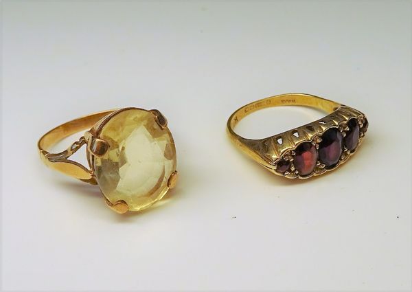 A 9ct gold and garnet five stone ring, Birmingham 1972, ring size Q and a gold ring, claw set with an oval cut citrine, ring size R and a half, combin