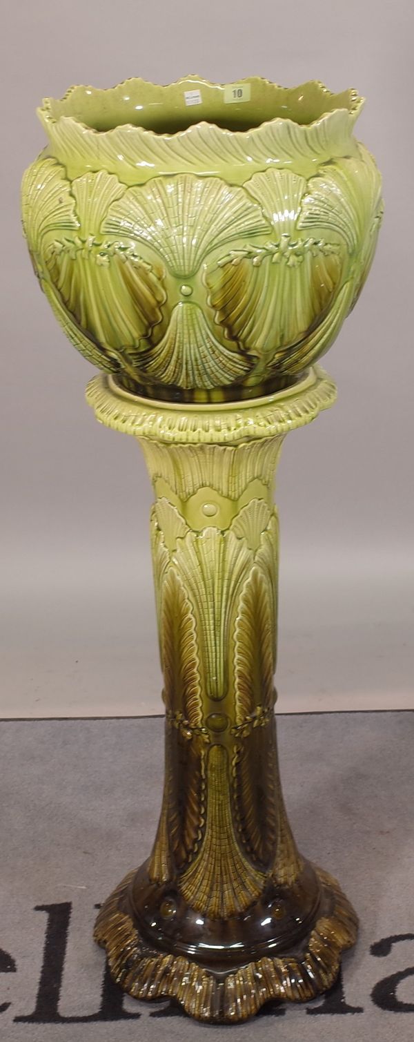 A green glaze Burmantofts jardiniere on stand, 35cm wide x 110cm high.