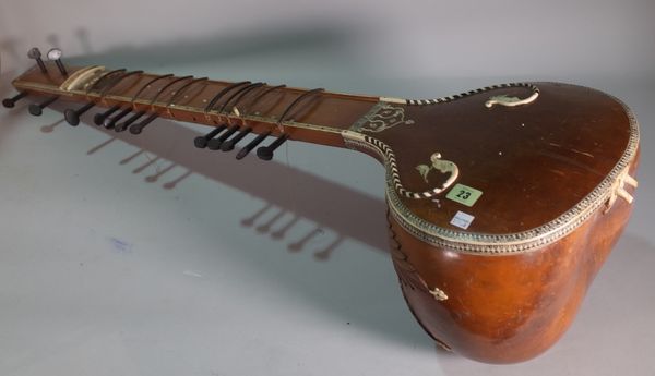 An Indian sitar with carved wood and ivory inlaid foliate decoration, applied trade label 'R.S. Mayekar, Bombay', 122cm.