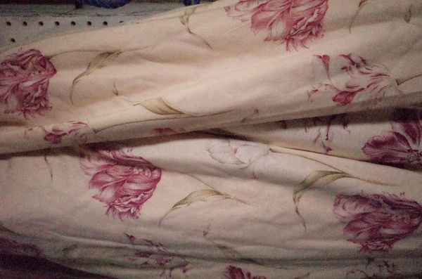 A pair of lined and interlined floral curtains, 150cm wide x 148cm drop.