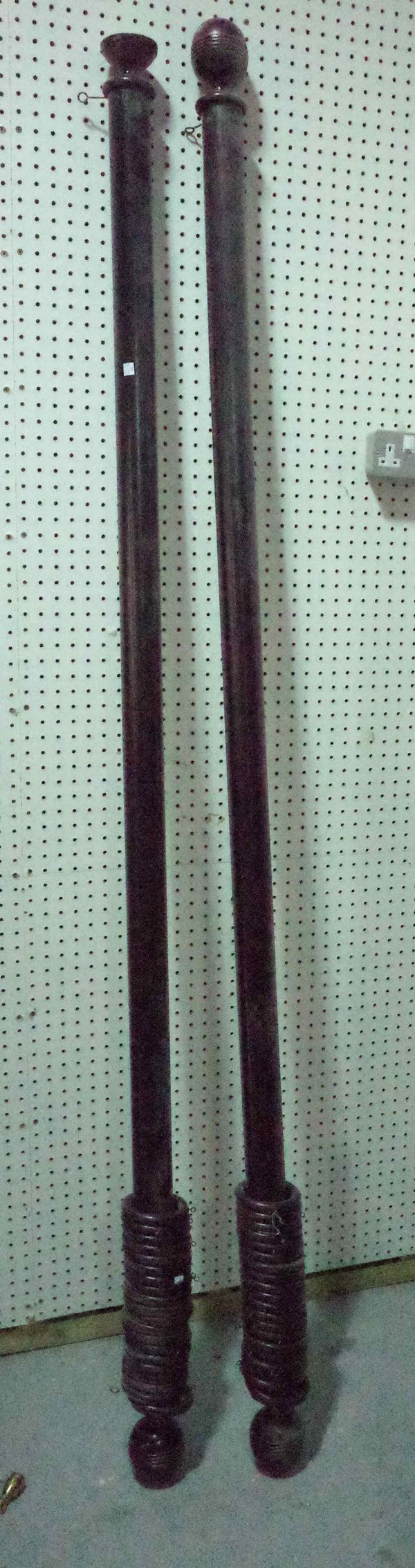 A pair of 20th century black painted beech curtain rails, 227cm long (2), (4 brass brackets).