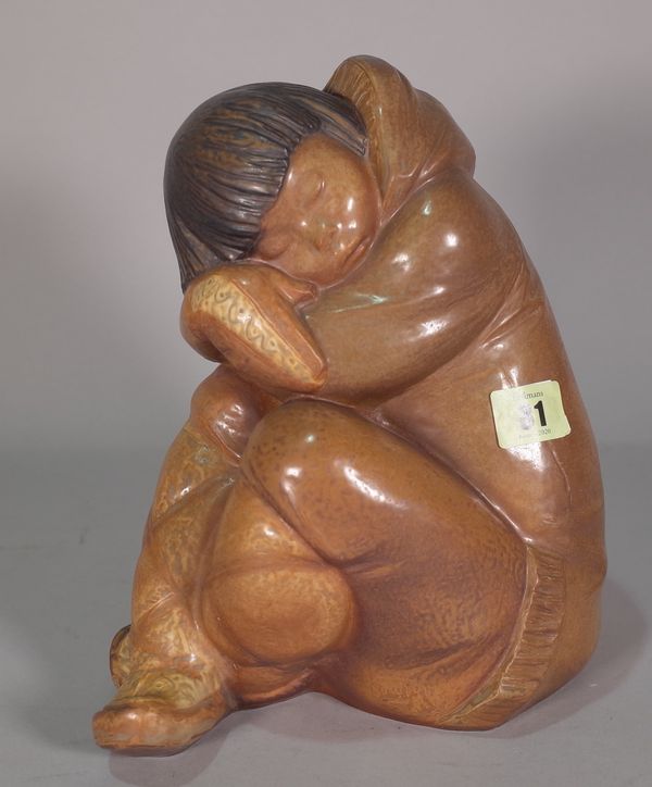 A Lladro matte glaze figure of a sleeping Eskimo, blue printed mark to base, 25cm high.