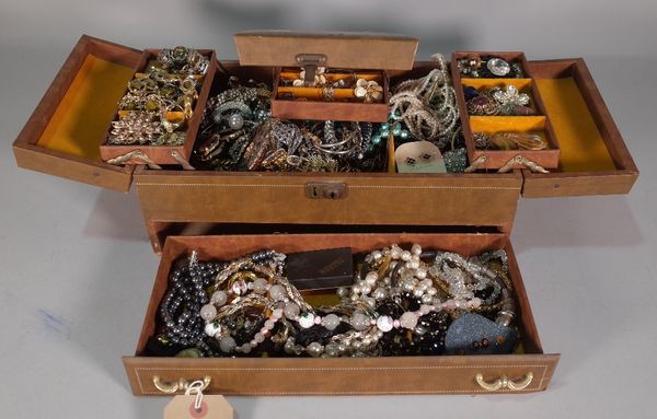 A quantity of mostly 20th century costume jewellery, within a leather jewellery box, 36cm wide x 14cm high.