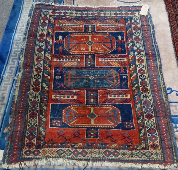 A Shirvan rug, the blue field with three lobed medallions, figures, 122cm x 98cm.