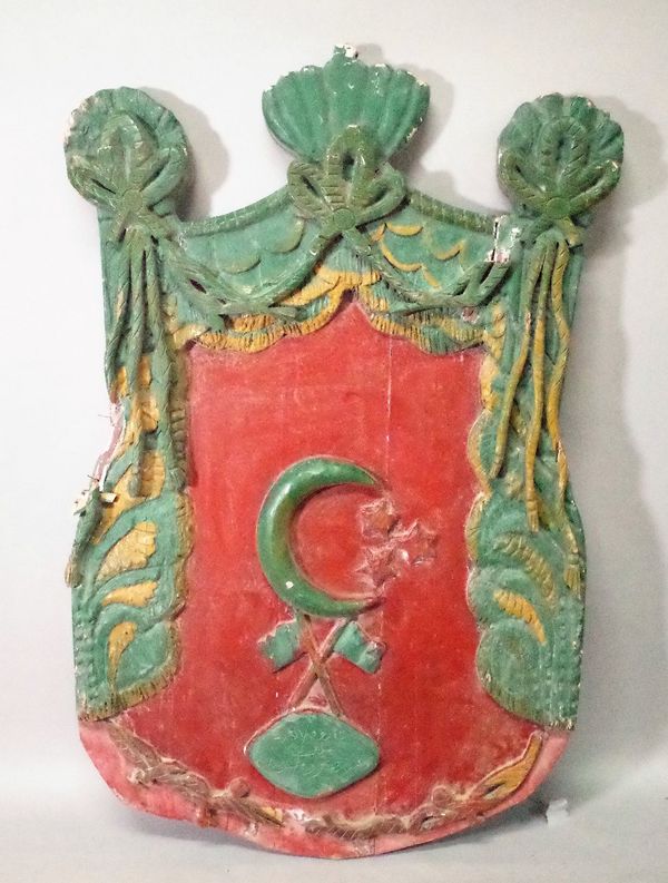 An early 20th century painted Turkish relief carved wall plaque, 96cm wide x 146cm high.