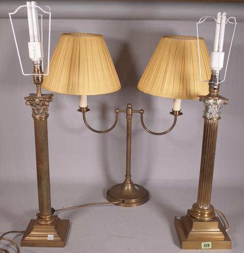 A near pair of early 20th century brass Corinthian column table lamps, 48cm high and a 20th century brass twin branch table lamp, 41cm high, (3).
