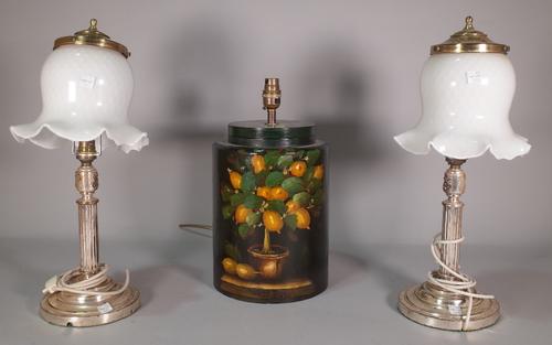 A pair of early 20th century silver plated table lamps with white glass shades, 44cm high and a 20th century painted lacquer table lamp, 37cm high, (3